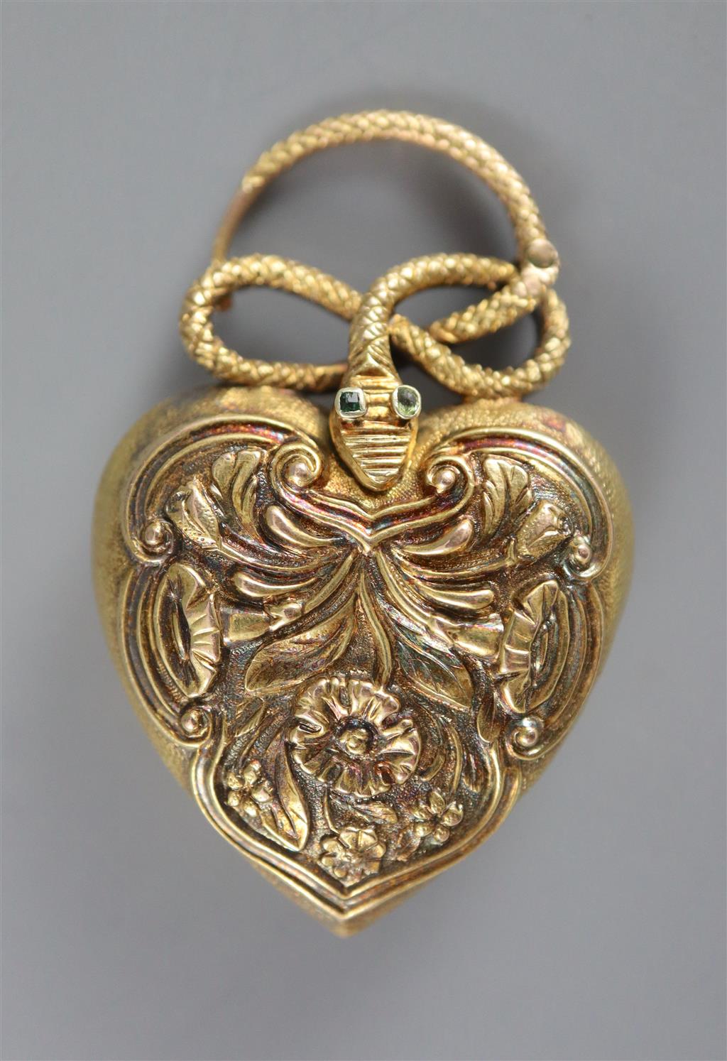 A Victorian gold and gem set heart shaped mourning pendant, with hinged serpent finial,